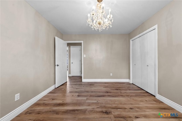 3610 Sierra Blanca Blvd, Temple, TX 76502 - unfurnished bedroom featuring a chandelier, wood finished floors, baseboards, and a closet
