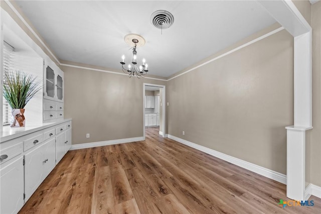 3610 Sierra Blanca Blvd, Temple, TX 76502 - unfurnished dining area featuring a chandelier, baseboards, and light wood-style floors