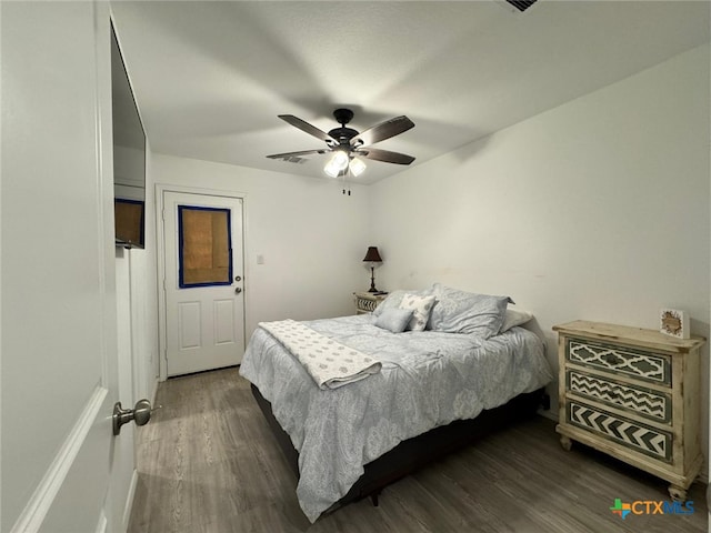 bedroom with ceiling fan and dark wood-type flooring