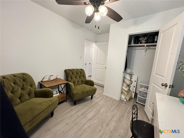 living area with ceiling fan and light wood-type flooring