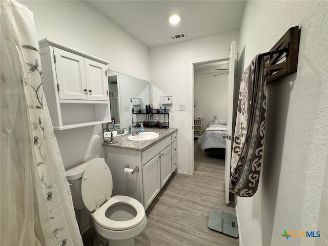 bathroom featuring hardwood / wood-style flooring, vanity, and toilet