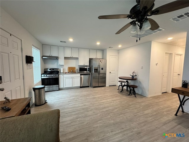 kitchen featuring ceiling fan, white cabinets, light wood-type flooring, and appliances with stainless steel finishes