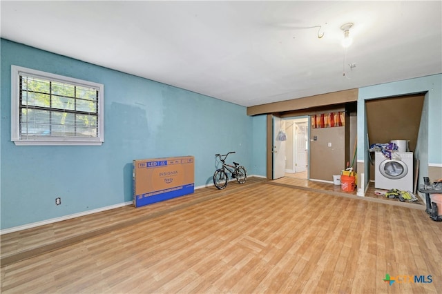 interior space with washer / clothes dryer and hardwood / wood-style flooring