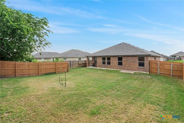 206 Danielle Dr, Killeen, TX 76542 - rear view of property featuring brick siding, a fenced backyard, and a shingled roof