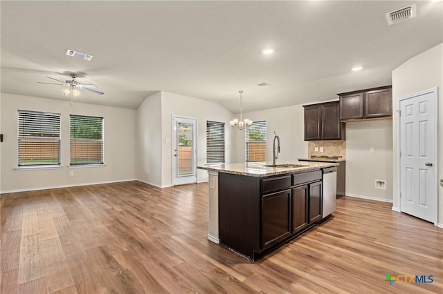206 Danielle Dr, Killeen, TX 76542 - kitchen with stainless steel dishwasher, a chandelier, light wood-style floors, dark brown cabinets, and open floor plan