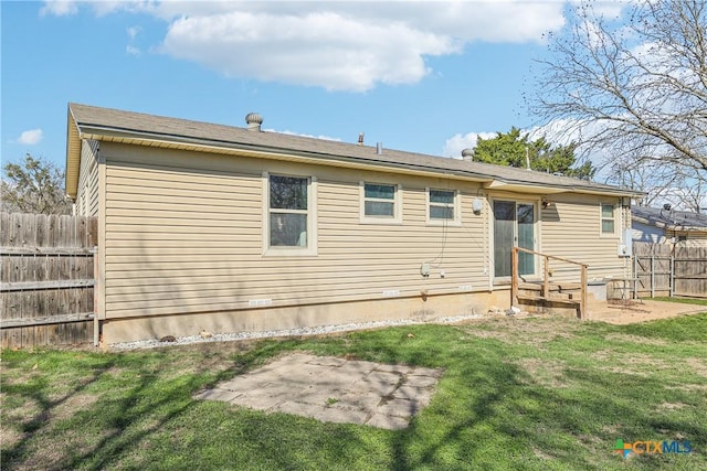 back of property with a patio, a lawn, and fence