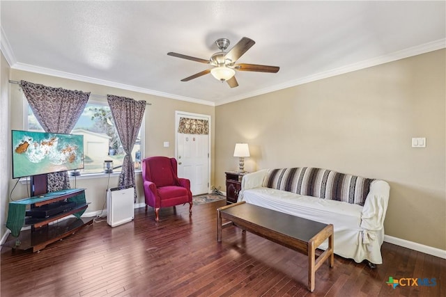 living area with baseboards, a ceiling fan, hardwood / wood-style flooring, and crown molding