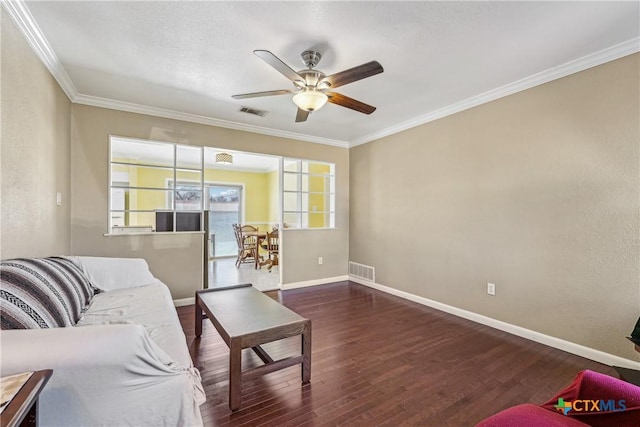 living room with baseboards, visible vents, wood finished floors, and ornamental molding