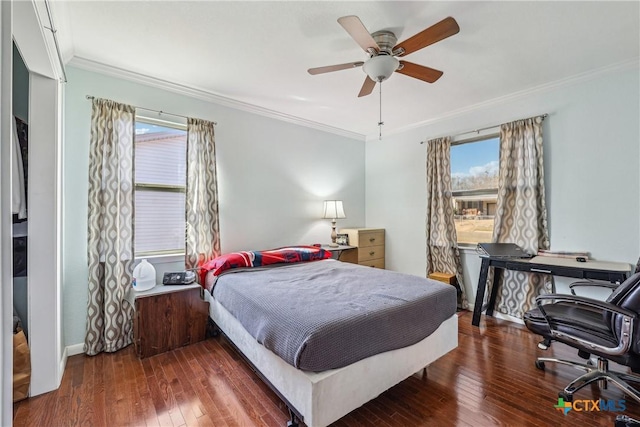 bedroom with wood-type flooring, ornamental molding, ceiling fan, and baseboards