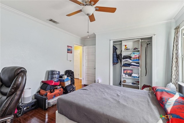 bedroom featuring a closet, visible vents, crown molding, and wood finished floors