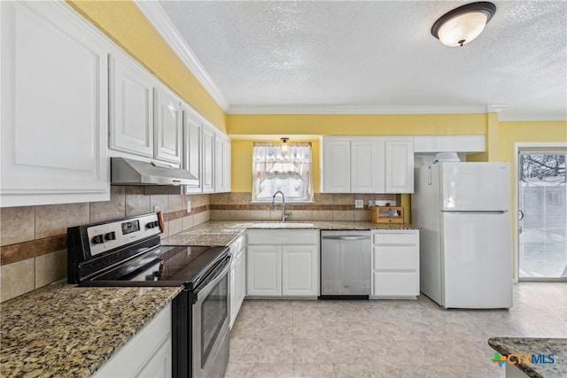 kitchen with tasteful backsplash, appliances with stainless steel finishes, white cabinets, a sink, and under cabinet range hood