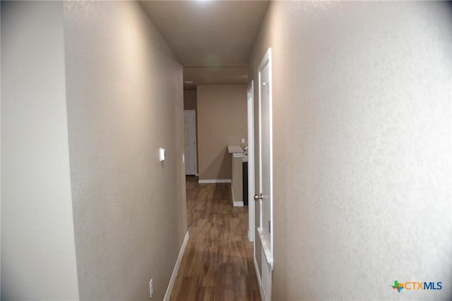 1204 N 18th St, Killeen, TX 76541 - hallway featuring wood finished floors, baseboards, and a textured wall