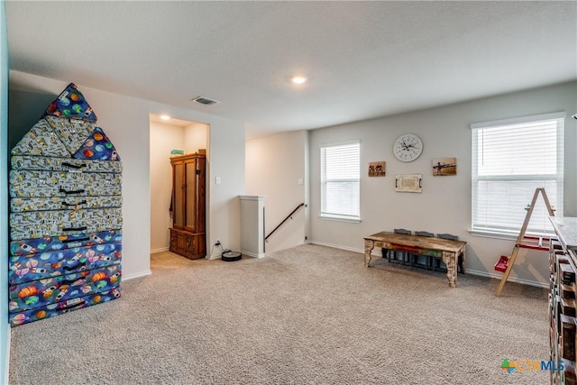 recreation room featuring plenty of natural light and carpet