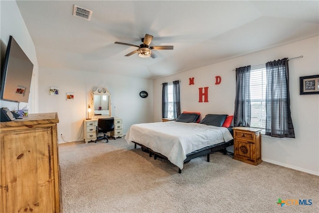 carpeted bedroom with ceiling fan and multiple windows