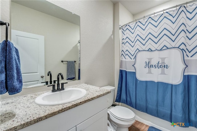 full bathroom with toilet, vanity, shower / bath combo, and hardwood / wood-style flooring