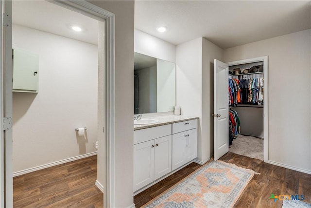 bathroom featuring hardwood / wood-style floors, vanity, and toilet