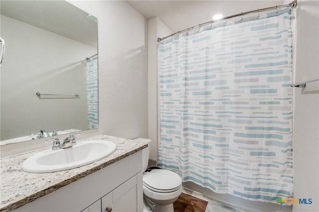 full bathroom featuring shower / bath combination with curtain, toilet, wood-type flooring, and vanity