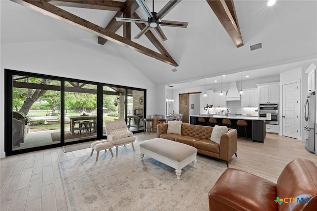 1306 Crystal Spgs, Salado, TX 76571 - living room with high vaulted ceiling, beam ceiling, light wood-style flooring, ceiling fan, and healthy amount of natural light