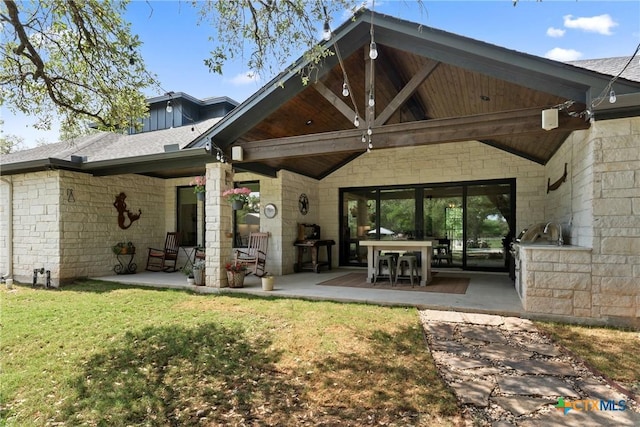 1306 Crystal Spgs, Salado, TX 76571 - rear view of property featuring a patio, a lawn, and stone siding