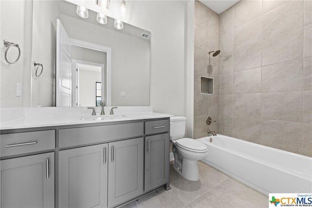 full bathroom with tile patterned flooring, vanity, toilet, and tiled shower / bath