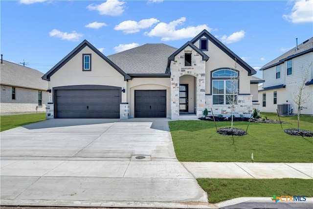 french country inspired facade featuring a front yard, cooling unit, stucco siding, concrete driveway, and stone siding