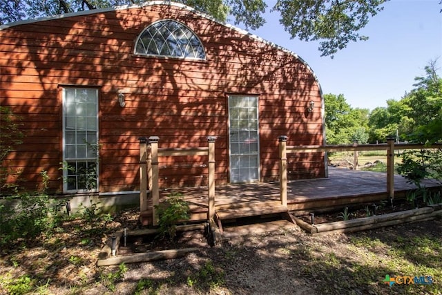 view of side of home featuring a wooden deck