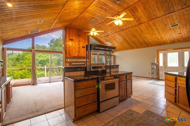 kitchen featuring electric stove, wooden ceiling, vaulted ceiling, ceiling fan, and tile countertops