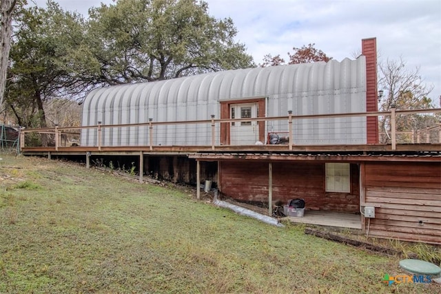 rear view of property with a lawn