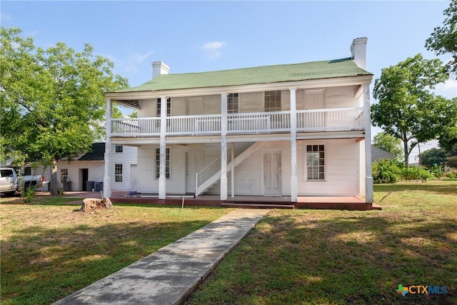 back of property featuring a yard