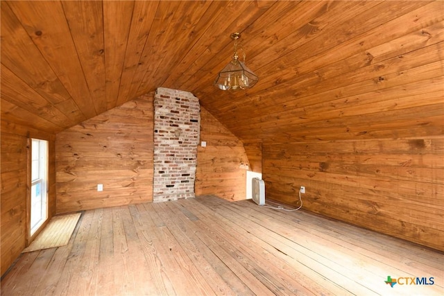 bonus room with wooden walls, wood ceiling, lofted ceiling, and light hardwood / wood-style floors