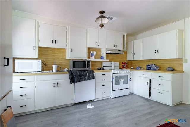 kitchen with white cabinets, white appliances, backsplash, and light hardwood / wood-style flooring