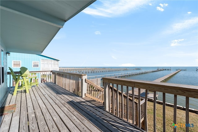 wooden deck featuring a water view