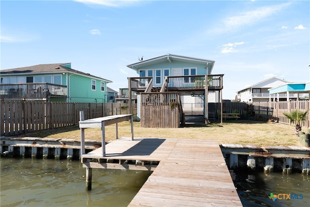 view of dock featuring a yard and a deck with water view