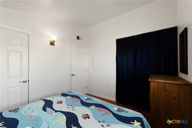 bedroom featuring dark wood-type flooring