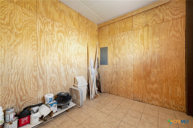 tiled empty room featuring electric panel and wooden walls