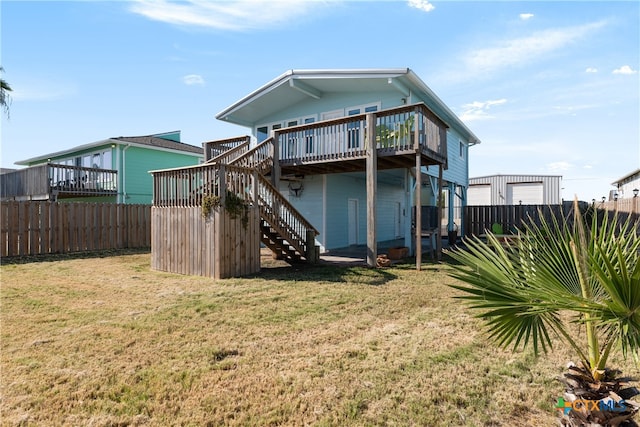 rear view of property featuring central air condition unit, a lawn, and a wooden deck