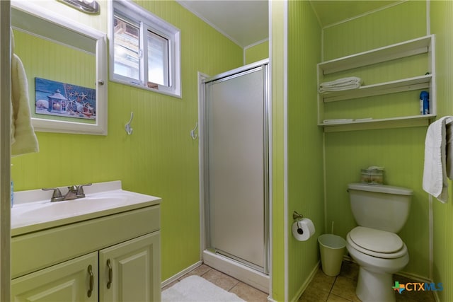 bathroom featuring tile patterned flooring, vanity, a shower with shower door, and toilet