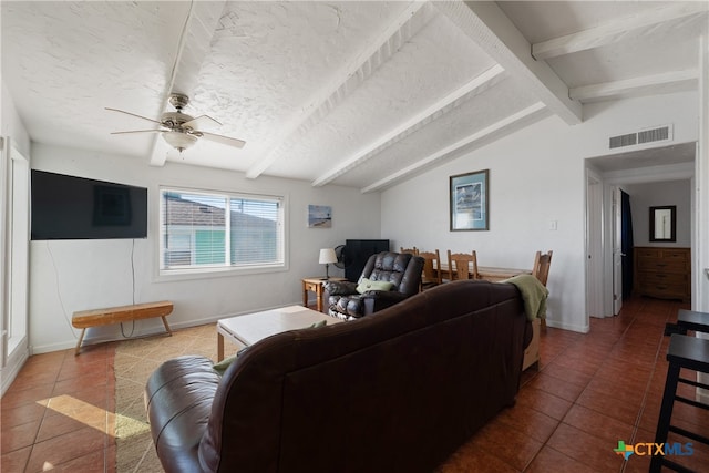 tiled living room with a textured ceiling, vaulted ceiling with beams, and ceiling fan