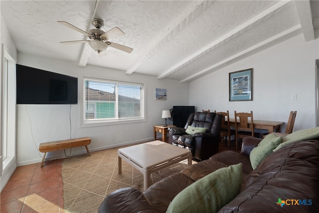 tiled living room with vaulted ceiling with beams, ceiling fan, and a textured ceiling