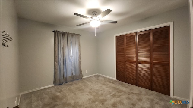 unfurnished bedroom featuring ceiling fan, carpet flooring, and a closet