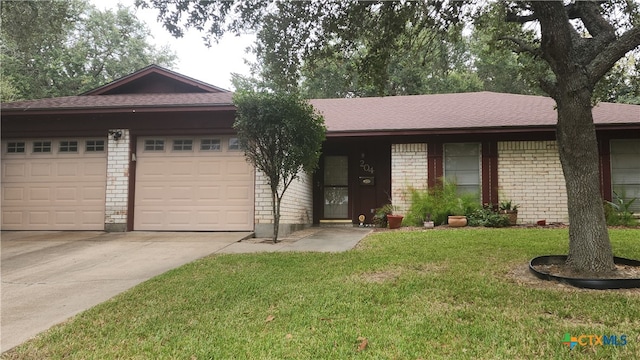 single story home with a garage and a front lawn