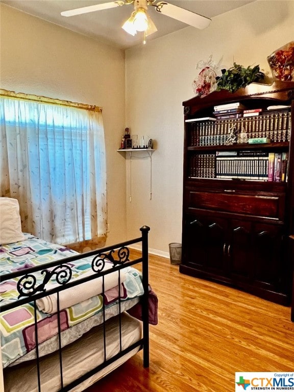 bedroom featuring hardwood / wood-style floors and ceiling fan