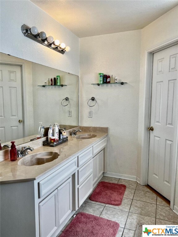 4305 Foster Ln, Killeen, TX 76549 - full bathroom with tile patterned floors and double vanity