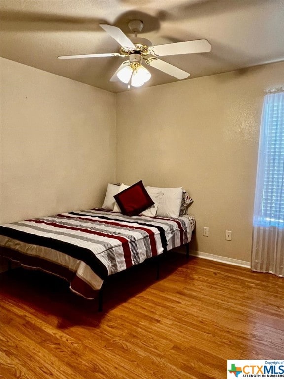 4305 Foster Ln, Killeen, TX 76549 - bedroom featuring wood finished floors, a ceiling fan, and baseboards