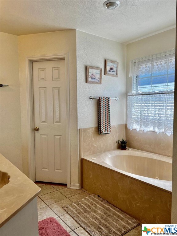 4305 Foster Ln, Killeen, TX 76549 - full bath with a bath, tile patterned flooring, and a textured ceiling