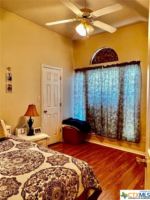 bedroom with hardwood / wood-style floors and ceiling fan