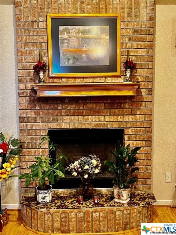 interior details featuring hardwood / wood-style flooring and a fireplace