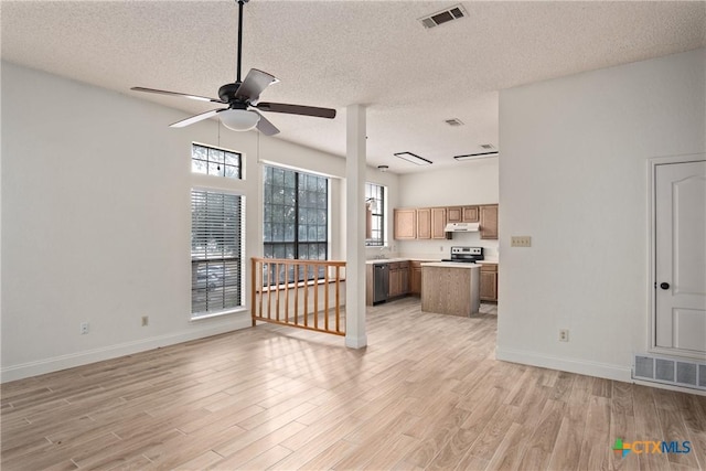 unfurnished living room with a textured ceiling, light hardwood / wood-style floors, and ceiling fan