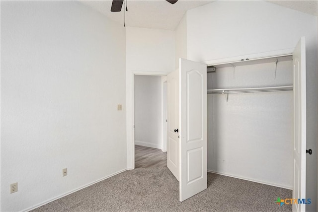 unfurnished bedroom featuring carpet flooring, ceiling fan, and a closet