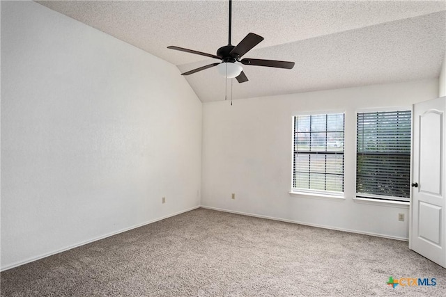 carpeted spare room with a textured ceiling, ceiling fan, and lofted ceiling